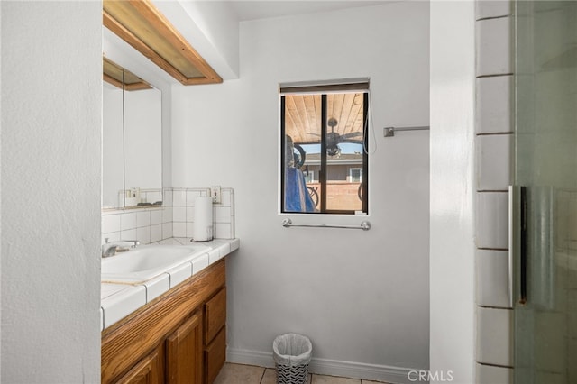 bathroom featuring tile patterned floors, a shower with shower door, and vanity