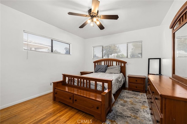 bedroom with light hardwood / wood-style floors and ceiling fan