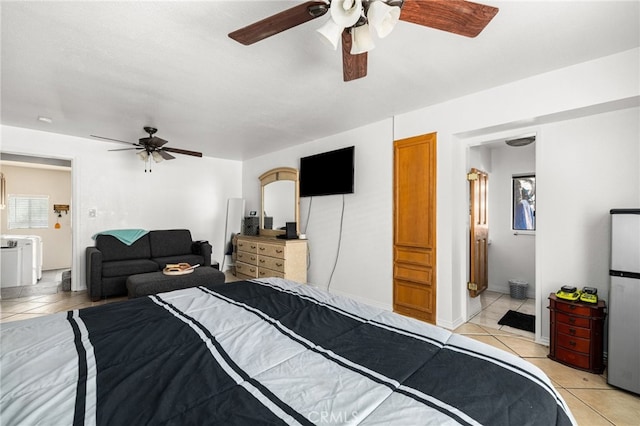 tiled bedroom with ceiling fan, connected bathroom, and stainless steel fridge