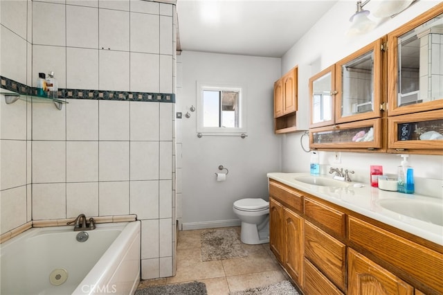 bathroom featuring tile patterned flooring, a bathing tub, toilet, and vanity