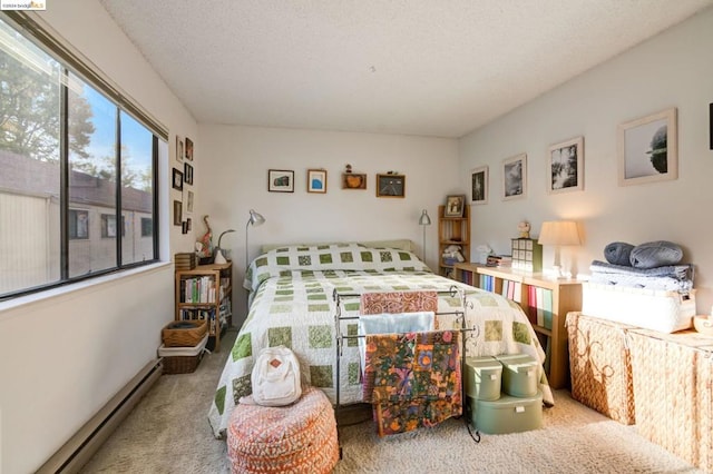 carpeted bedroom featuring a baseboard radiator and a textured ceiling