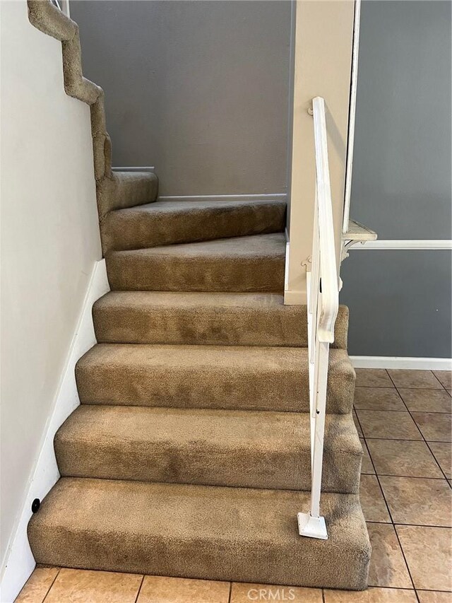 stairs featuring tile patterned flooring