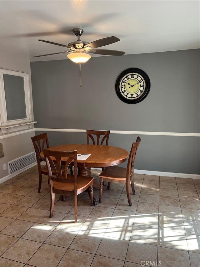 tiled dining area with ceiling fan