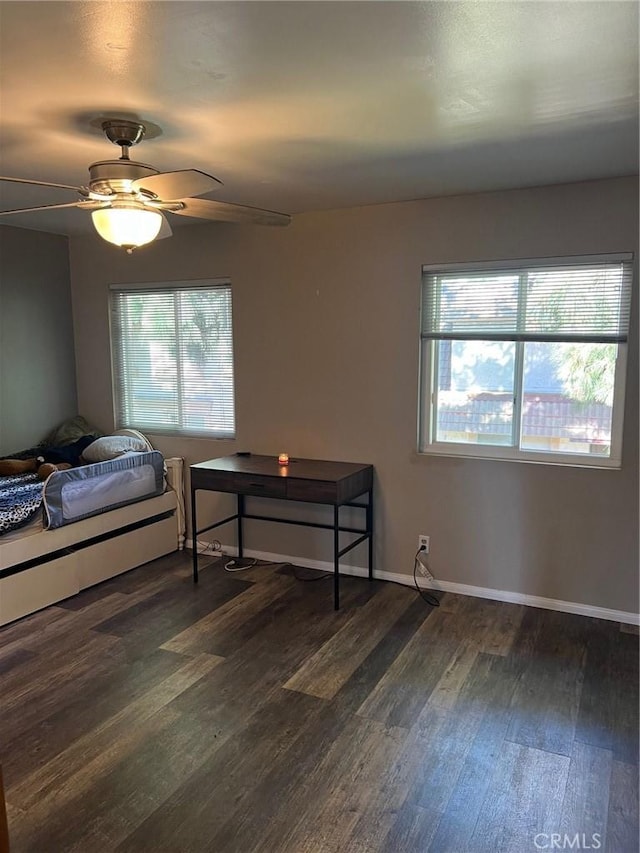 bedroom featuring ceiling fan and dark hardwood / wood-style floors