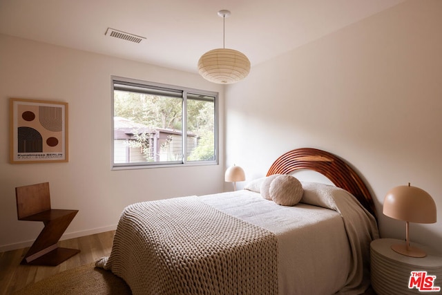 bedroom with hardwood / wood-style flooring