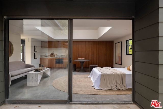 bedroom with wood walls and sink