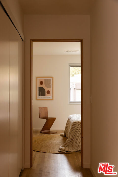 corridor featuring wood-type flooring