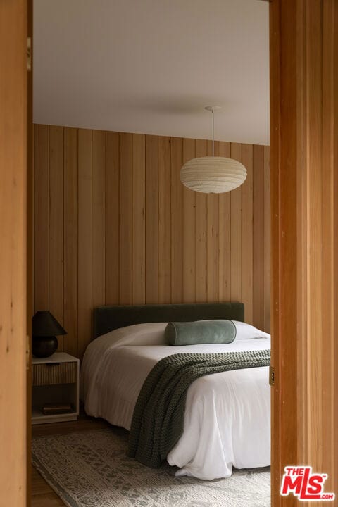 bedroom with wood walls