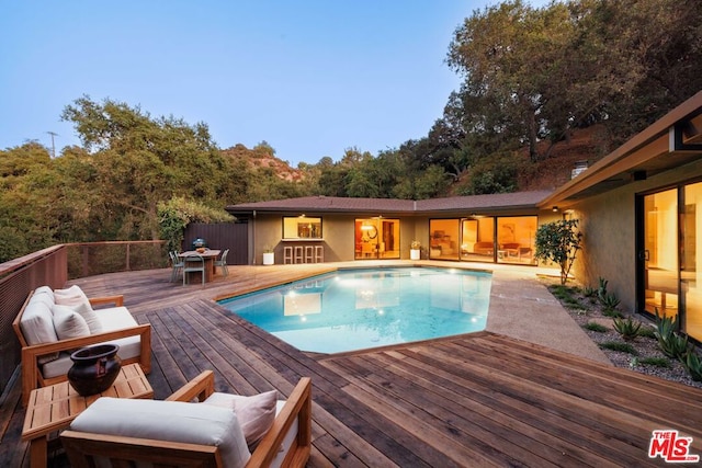 view of swimming pool featuring a wooden deck