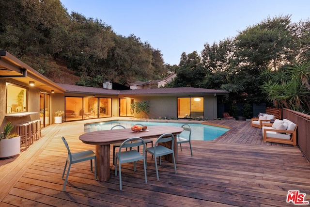 view of swimming pool featuring an outdoor hangout area and a wooden deck