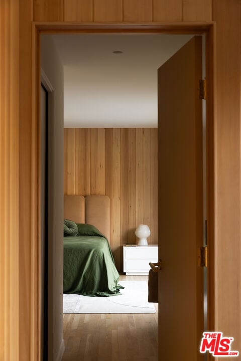 unfurnished bedroom with wooden walls