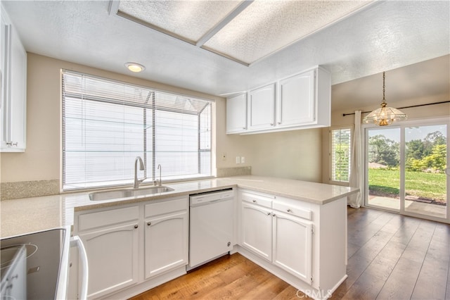 kitchen featuring white cabinets, white dishwasher, and decorative light fixtures