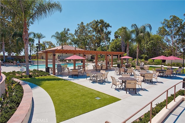 view of home's community featuring a swimming pool, a yard, and a patio area