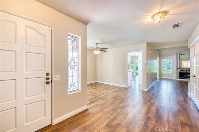 foyer with dark hardwood / wood-style floors and ceiling fan