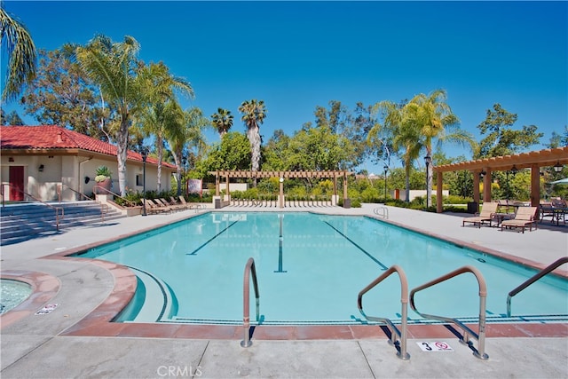 view of swimming pool featuring a pergola and a patio area