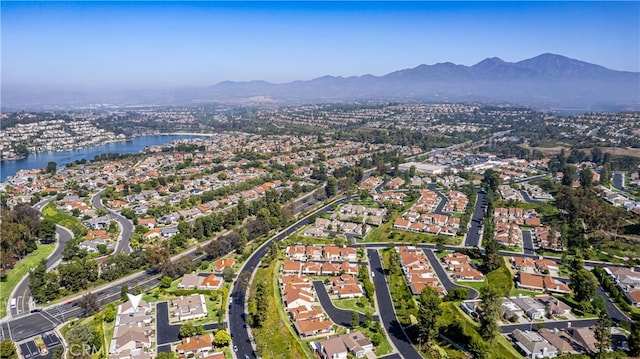 drone / aerial view featuring a water and mountain view