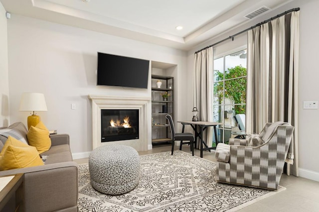 living area with a tray ceiling