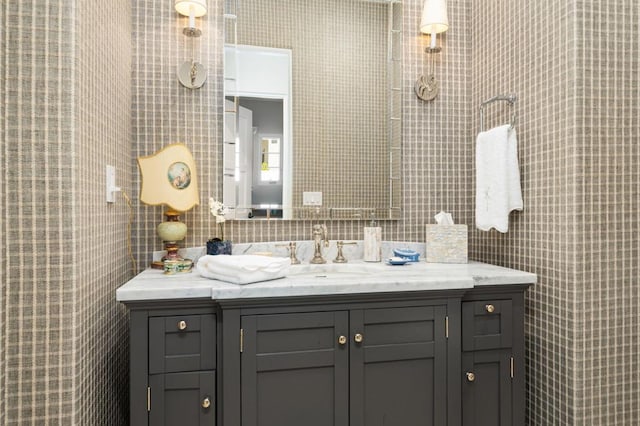 bathroom with vanity and tile walls