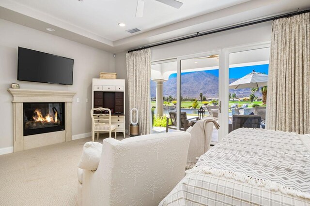 bedroom with carpet flooring, ceiling fan, and access to exterior