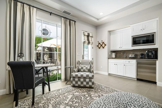 living area with light tile patterned floors and a wealth of natural light