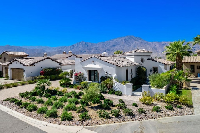 mediterranean / spanish-style house featuring a mountain view and a garage