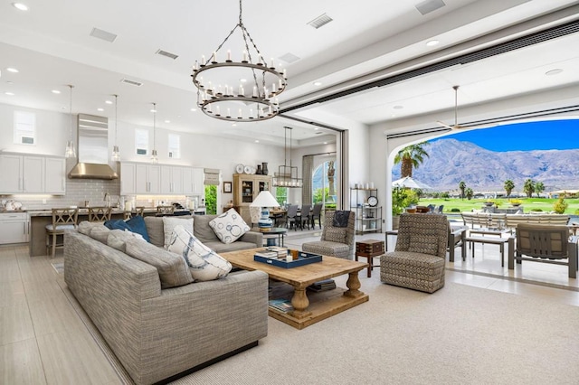 tiled living room featuring a mountain view and a notable chandelier