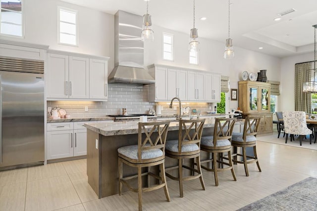 kitchen with white cabinets, plenty of natural light, and stainless steel appliances