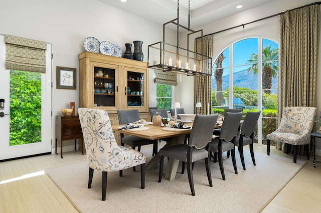 dining area with a mountain view, plenty of natural light, and a notable chandelier