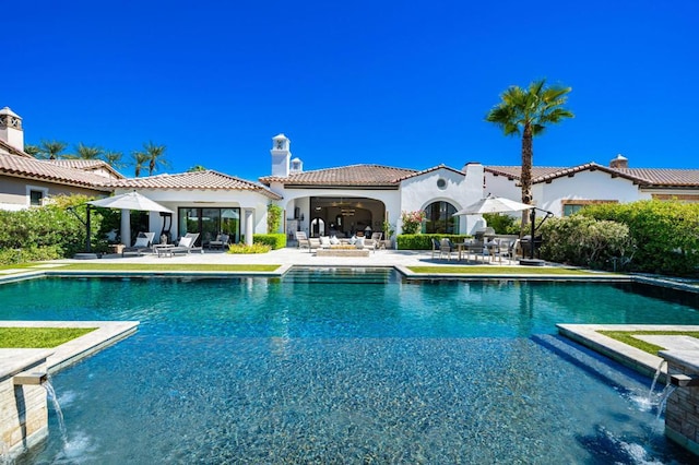 view of pool featuring pool water feature and a patio area