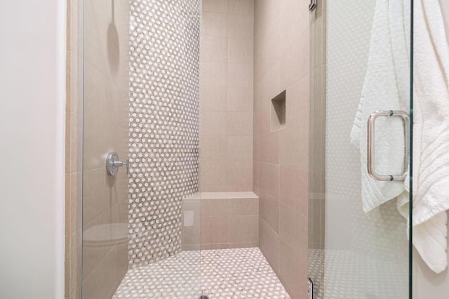 bathroom featuring a shower with door