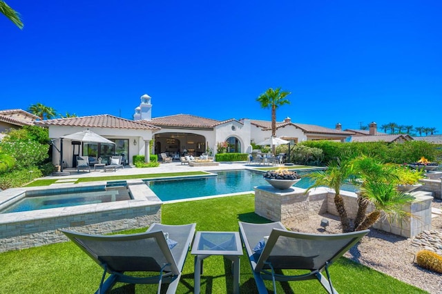 view of swimming pool with a patio area and an in ground hot tub