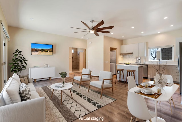 living room with light wood-type flooring and ceiling fan