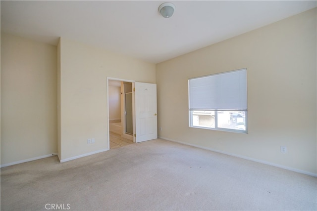 unfurnished bedroom featuring light carpet