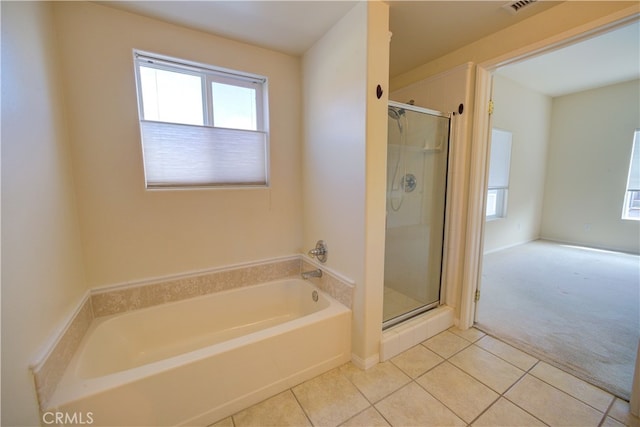 bathroom featuring tile patterned flooring and separate shower and tub