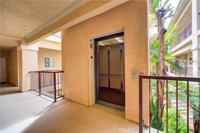 entrance to property featuring a balcony and elevator