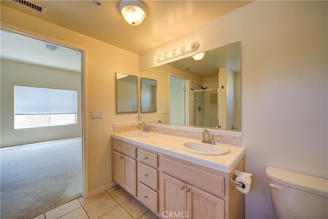 bathroom featuring vanity, tile patterned floors, an enclosed shower, and toilet