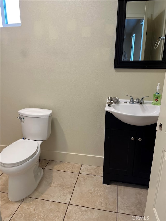 bathroom featuring tile patterned flooring, vanity, and toilet