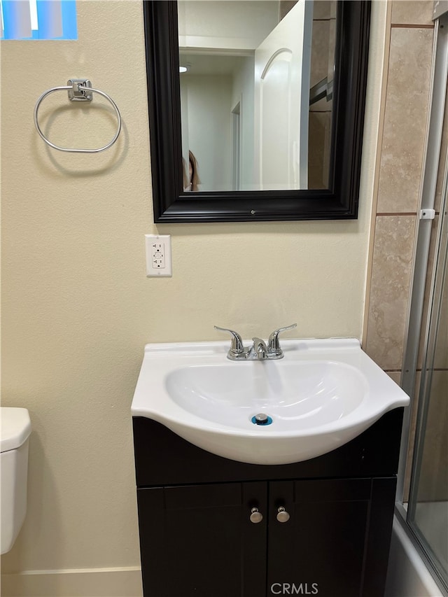 full bathroom with shower / bath combination with glass door, vanity, and toilet