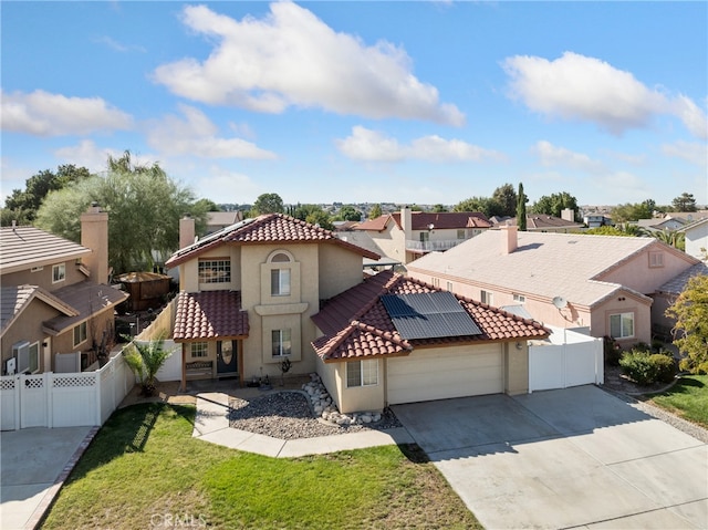 mediterranean / spanish-style house with a front lawn and a garage