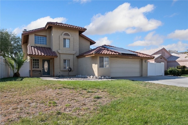 mediterranean / spanish home featuring a front lawn, solar panels, and a garage