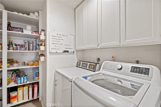 laundry room with cabinets and washing machine and clothes dryer