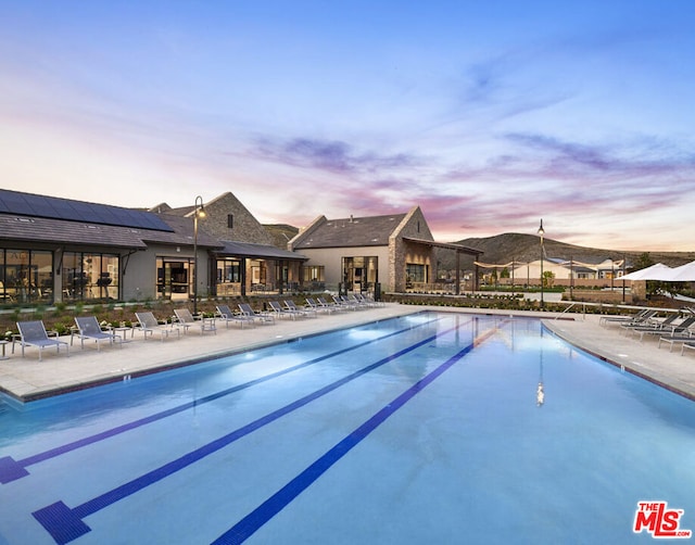 pool at dusk with a patio