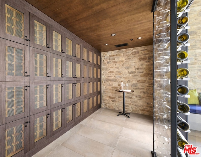 wine area with light tile patterned flooring and wood ceiling