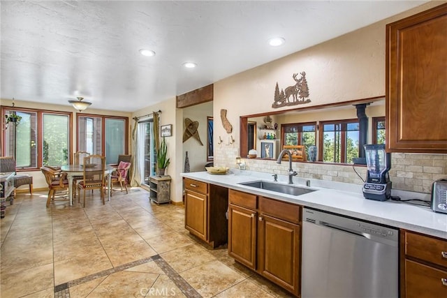 30421 Live Oak Dr, Running Springs, CA 92382 - kitchen featuring light countertops, decorative backsplash, stainless steel dishwasher, and a sink