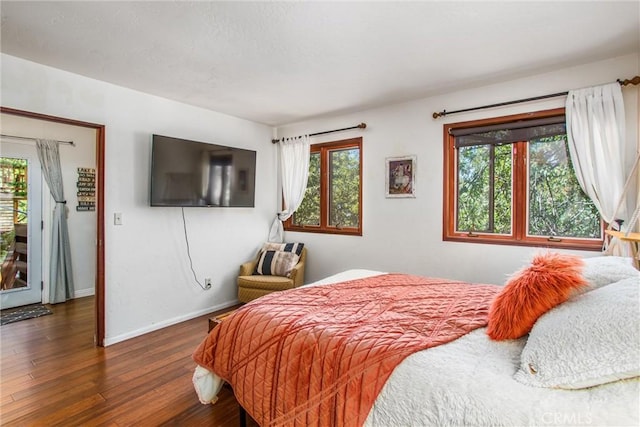 bedroom with dark hardwood / wood-style floors