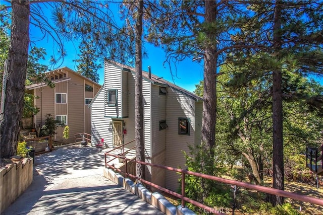 30421 Live Oak Dr, Running Springs, CA 92382 - view of side of home with a patio and fence