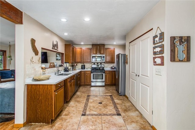 30421 Live Oak Dr, Running Springs, CA 92382 - kitchen with stainless steel appliances, a sink, decorative backsplash, brown cabinets, and light countertops