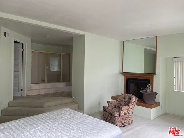 bedroom featuring light carpet and a closet