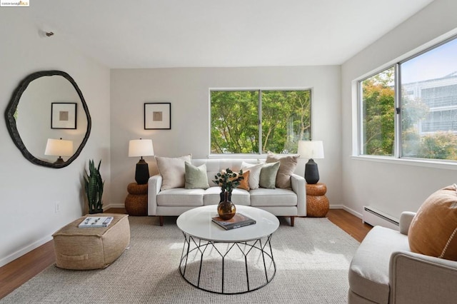 living room featuring baseboard heating and wood-type flooring