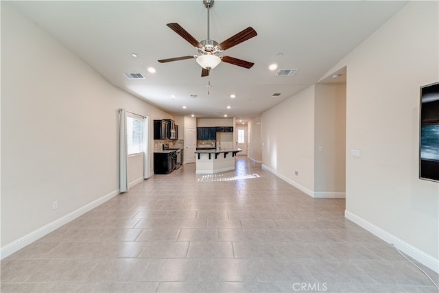 unfurnished living room featuring ceiling fan and light tile patterned floors